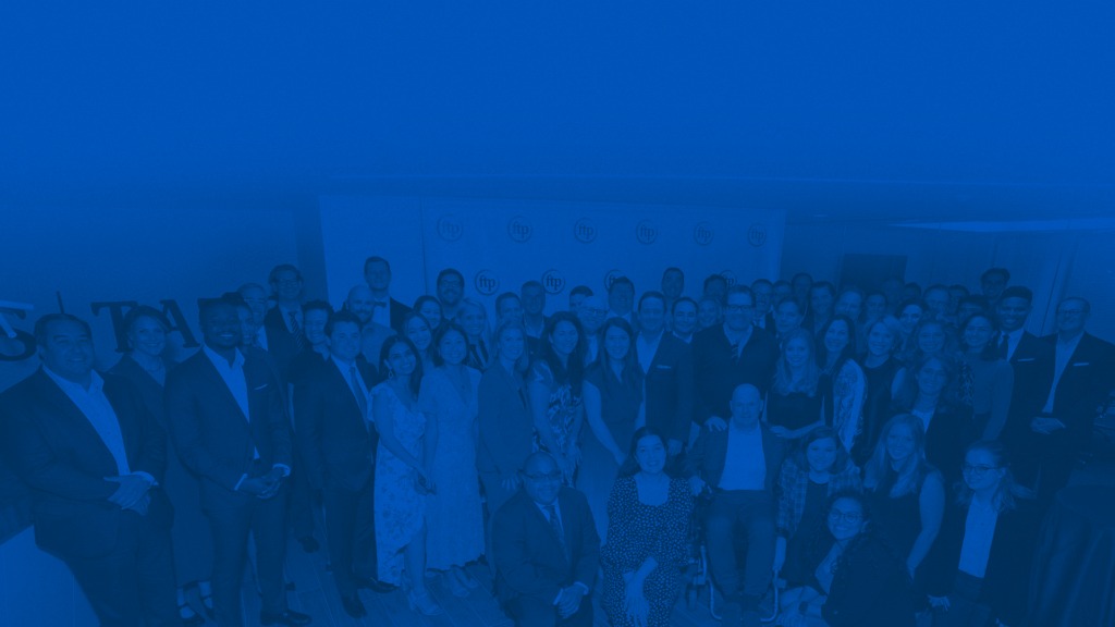 The FTP team gathered at a company event under blue lighting