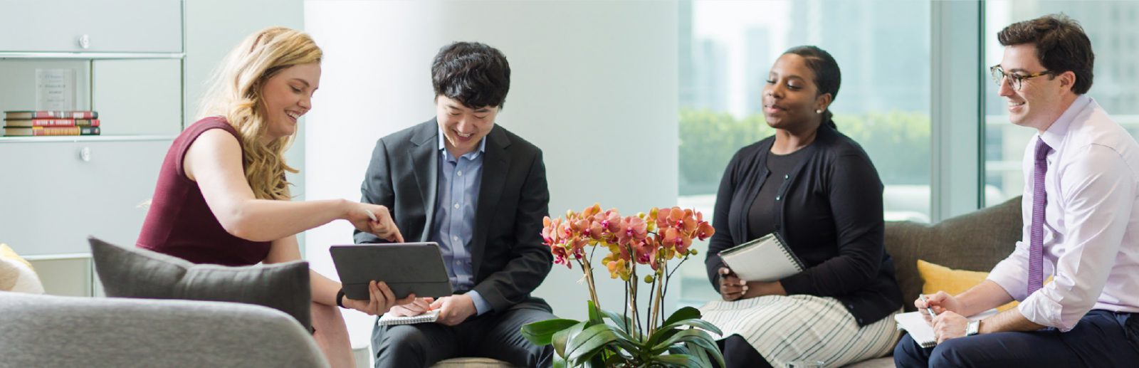 Four people in discussion around a tablet in a photograph published on FTV Capital’s company website