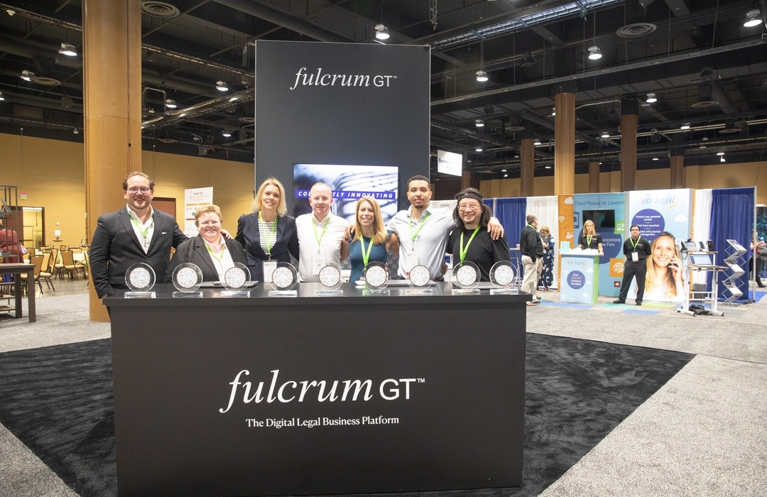 Fulcrum GT team standing together at their ALA 2022 conference booth