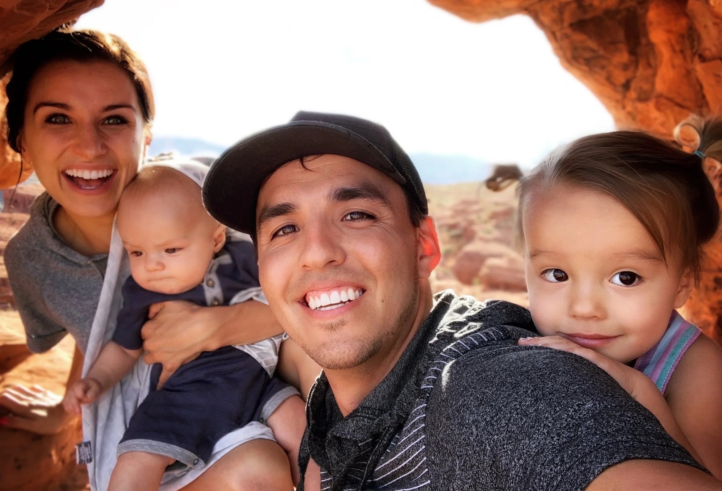 Parker Walbeck with his family beneath a red-rock overhang