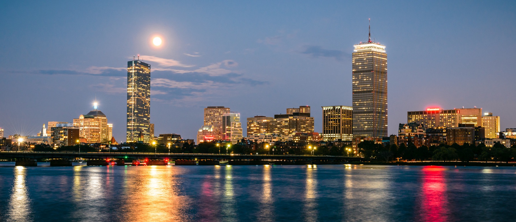 Boston skyline at dusk, reflected in the Charles River
