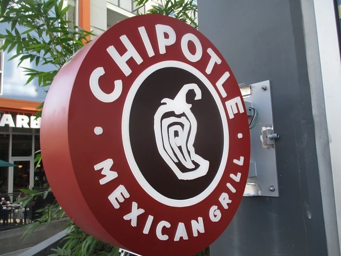 Round Chipotle projecting sign mounted outside a restaurant