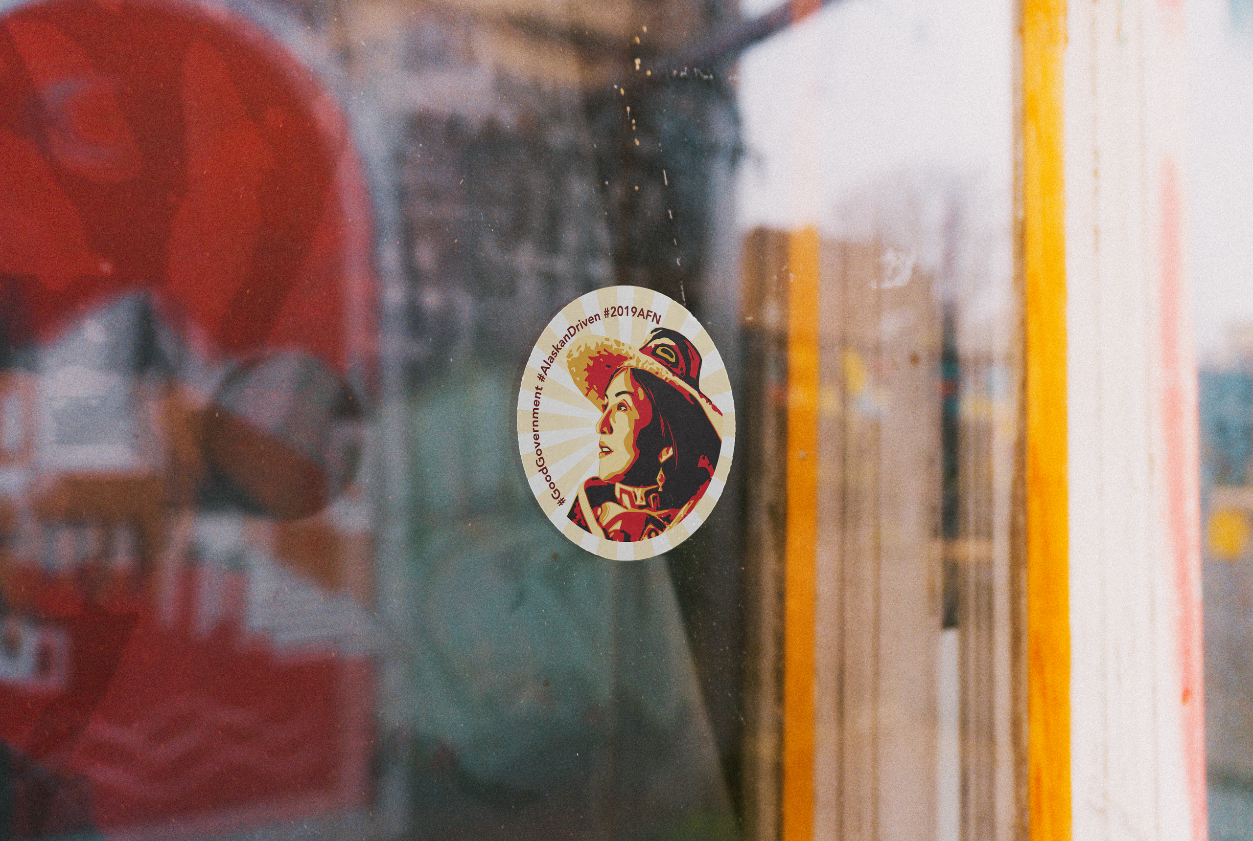 An Alaska Native-themed Good Government sticker on a shop window