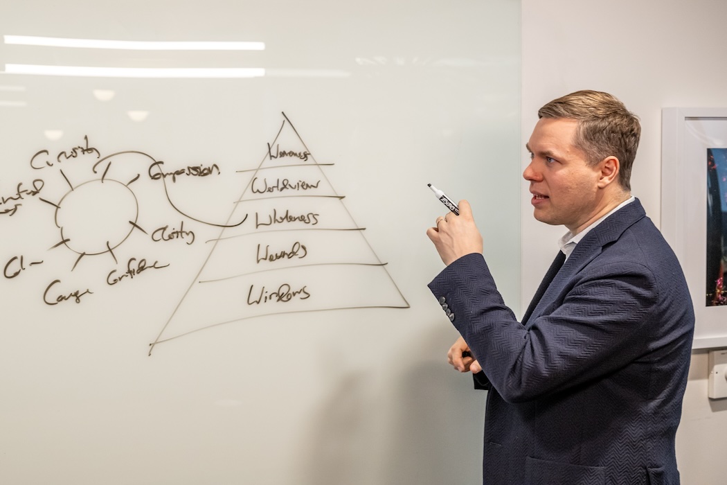 FutureSight founder John Carbrey working through ideas at a whiteboard