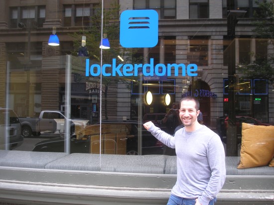 Gabe Lozano points to the LockerDome sign outside its Washington Avenue office in St. Louis.