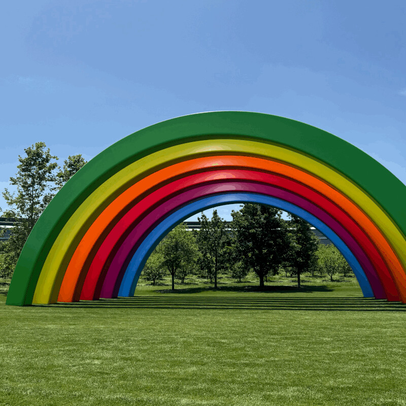 Apple Park's rainbow arch under a blue sky