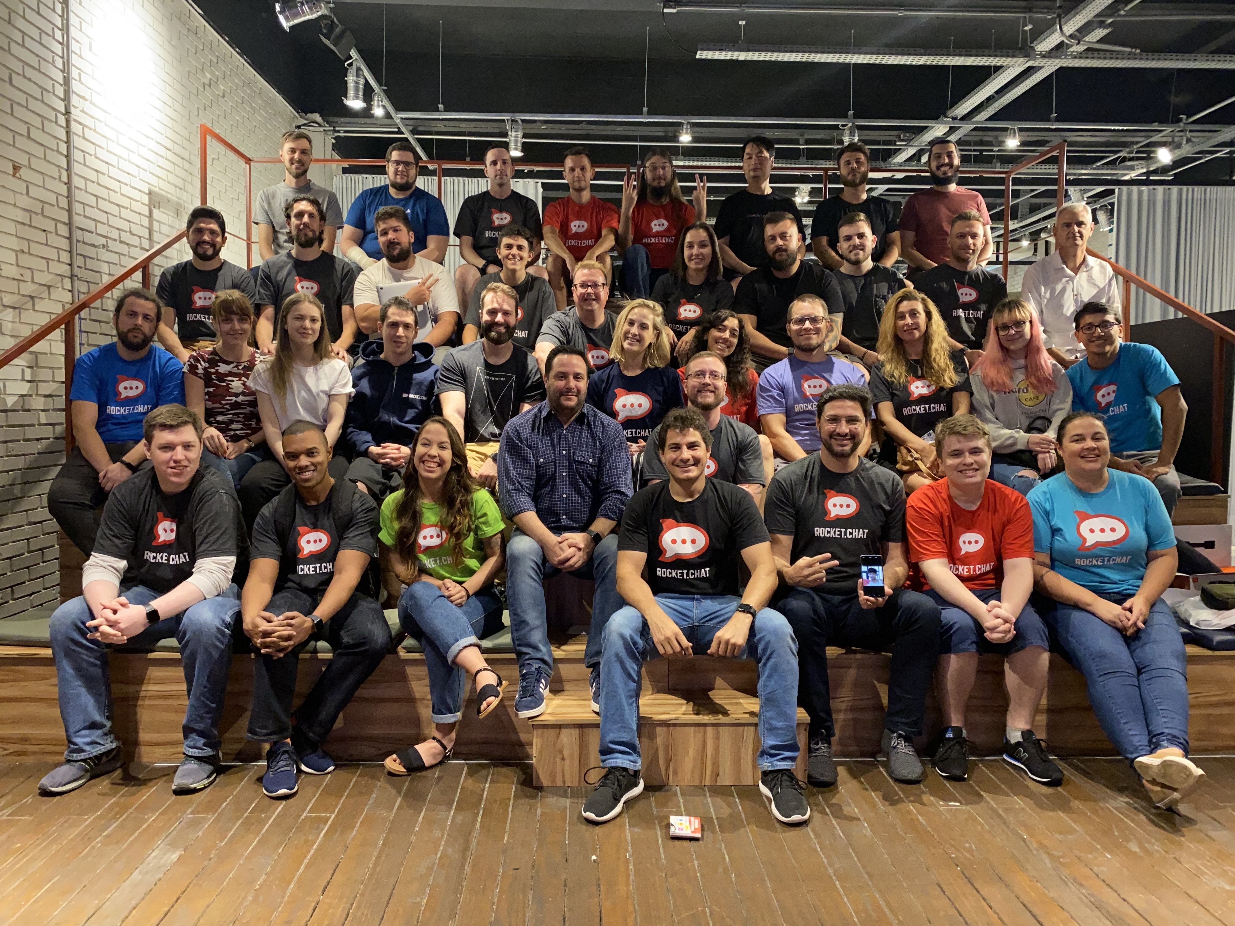 Rocket.Chat colleagues posing together on indoor steps