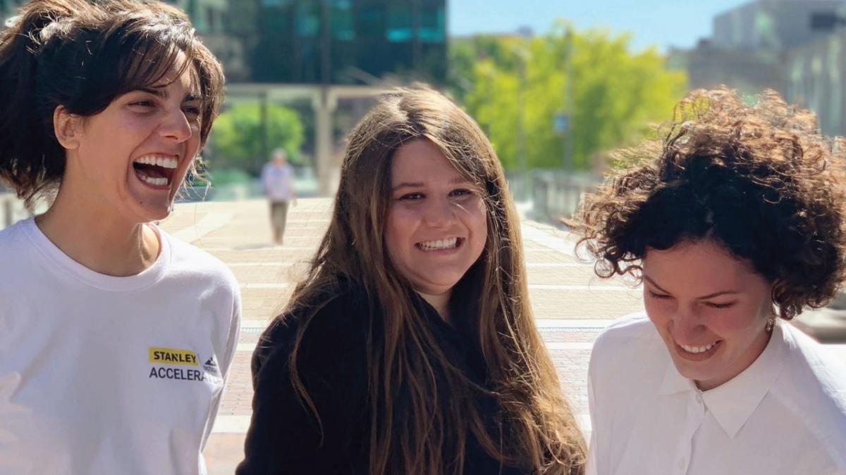 Gabriela Trueba, center, outdoors with two Womp colleagues