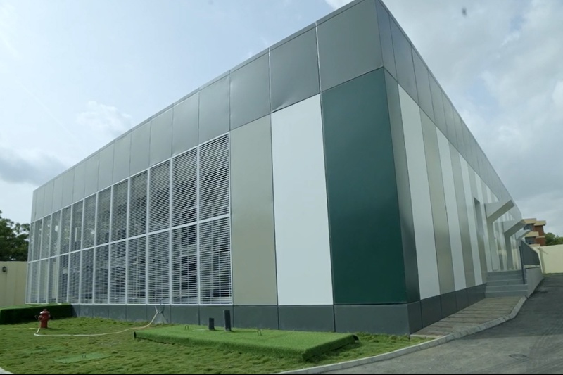 Exterior of a Galaxy Backbone data-centre building with ventilation panels and a grass verge