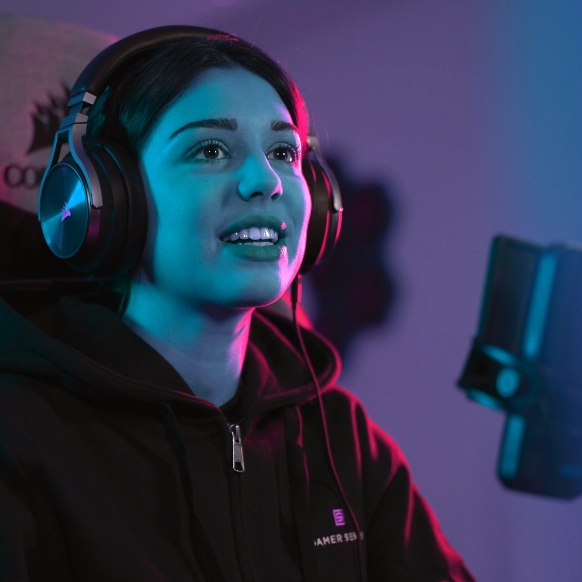 Gamer Sensei coaching promotional portrait of a headset-wearing gamer beside a microphone