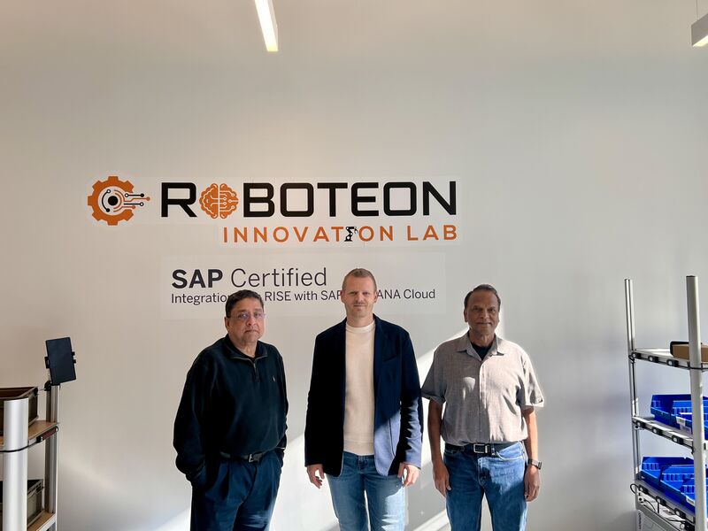 Gana Govind, at right, with Dmitry Antanovich and Shyam K. standing among equipment at the Roboteon Innovation Lab