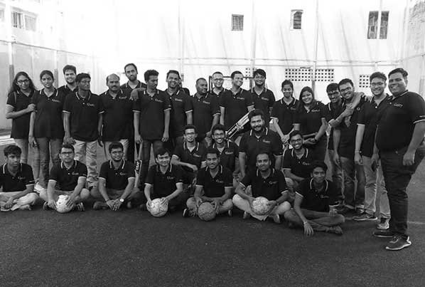 Ganit colleagues gathered for a team photograph on a sports ground
