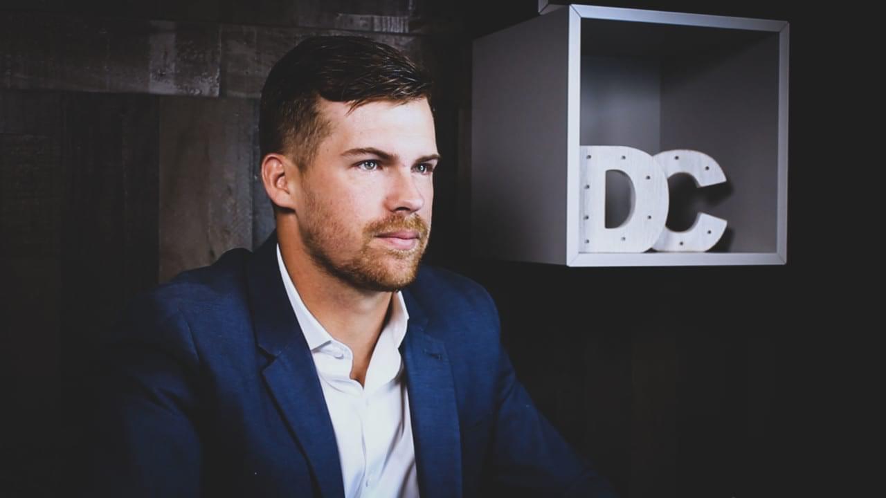 Garrett Mehrguth in a blue jacket beside Directive Consulting initials