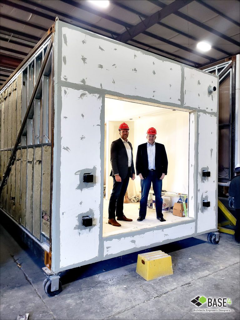 Blair Hildahl and Garry Vermaas standing inside a modular unit