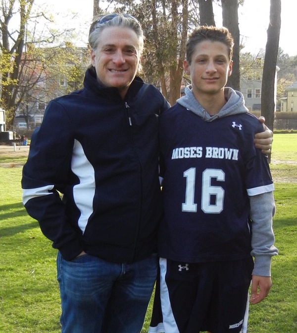 Gary Goldberg standing beside his son in a Moses Brown sports jersey