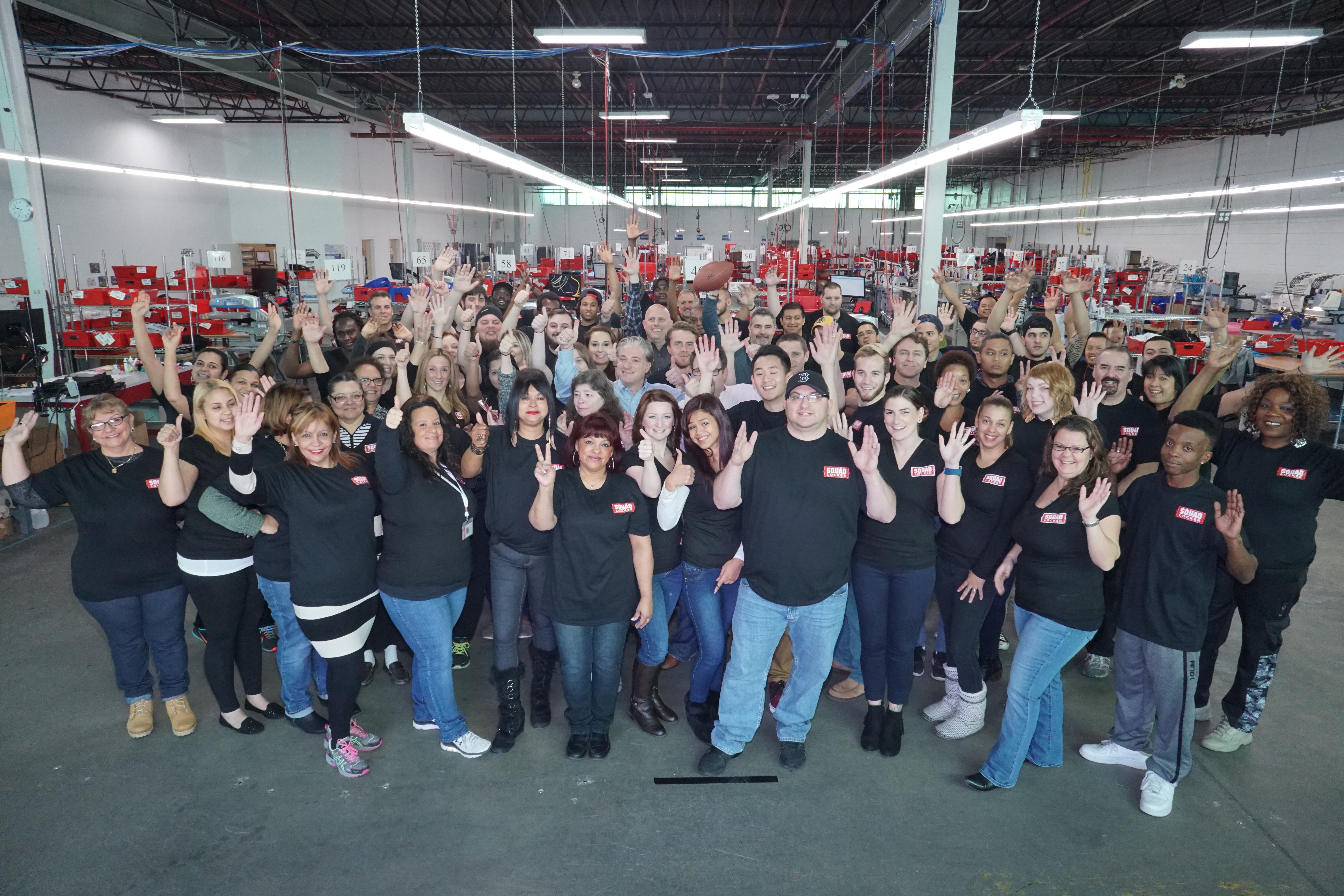 SquadLocker employees gathered on the production floor in Warwick, Rhode Island