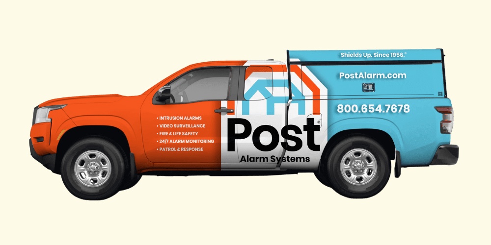 Post Alarm service truck with orange, white and turquoise Gatorwraps graphics
