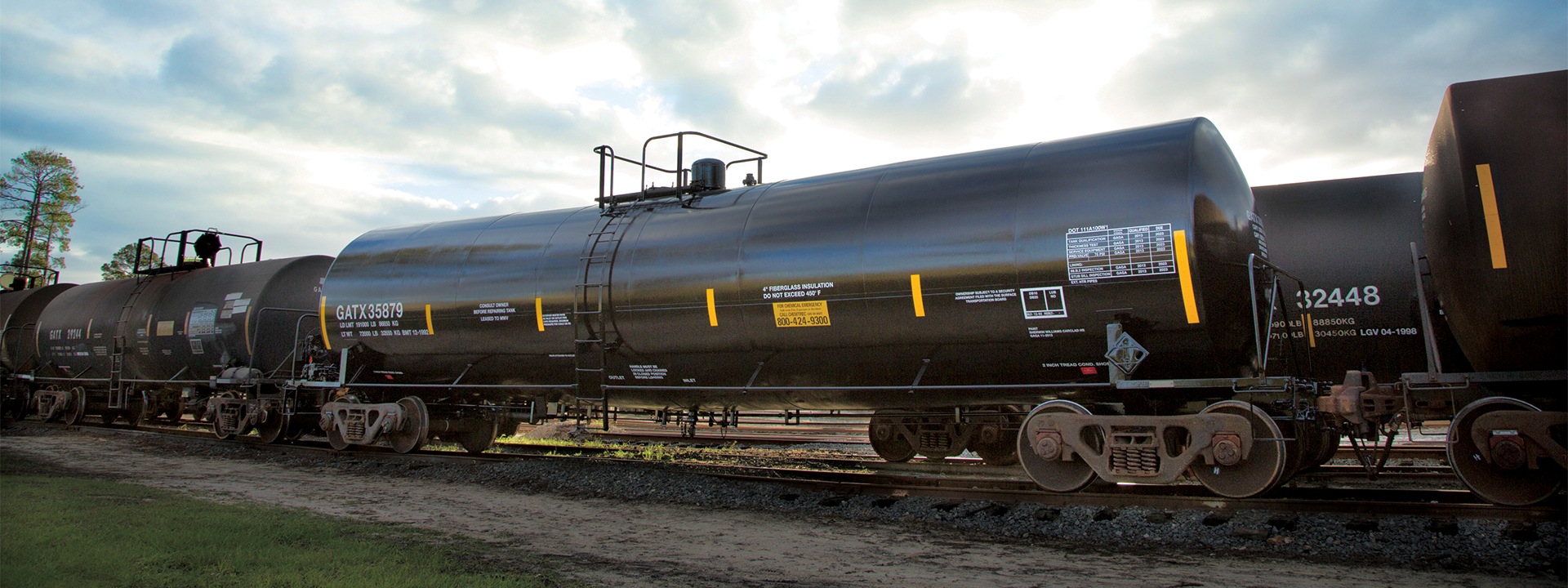 Black GATX tank railcars standing on railway tracks