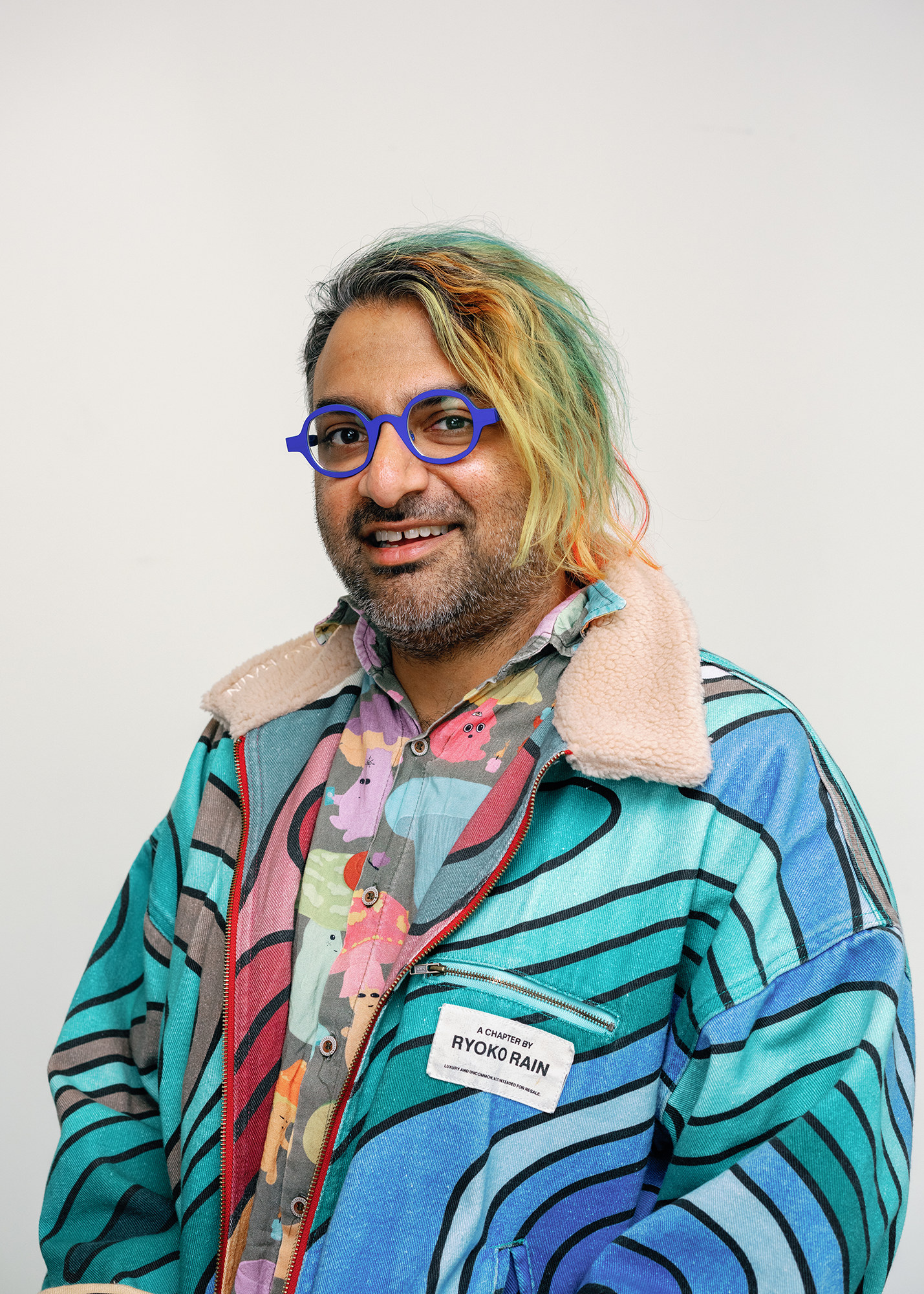 Gauntlet co-founder and CEO Tarun Chitra in blue glasses and a colorful patterned jacket