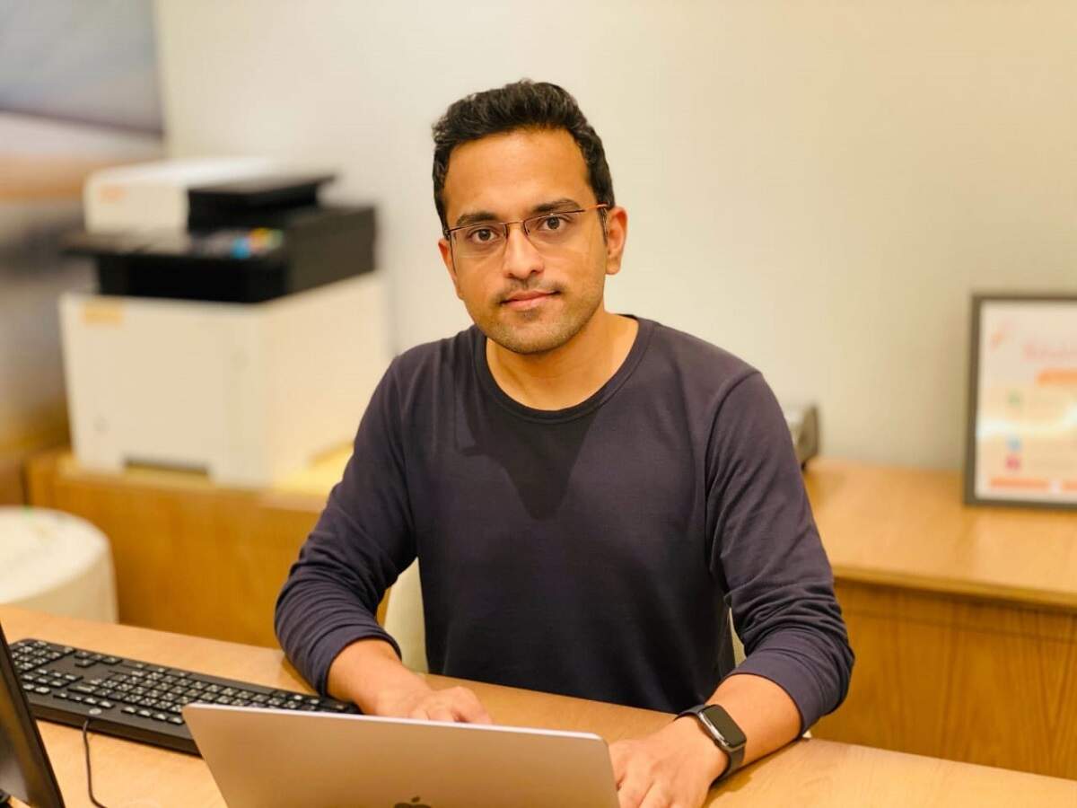 Gaurav Singh seated at a desk with a laptop in an office