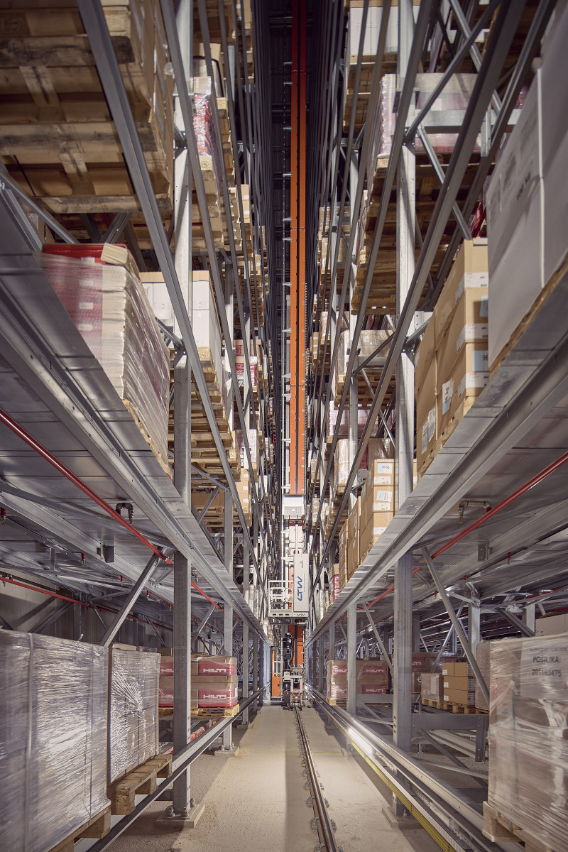Tall pallet racks and automated storage machinery inside the Wolfurt high-bay warehouse