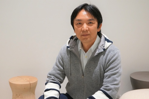 Gen Isayama seated during his December 2022 interview at WiL