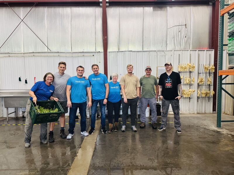 Members of the GenAlpha team standing together inside an industrial building