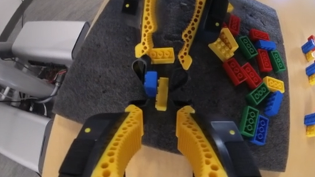 Robot grippers assembling colored building blocks