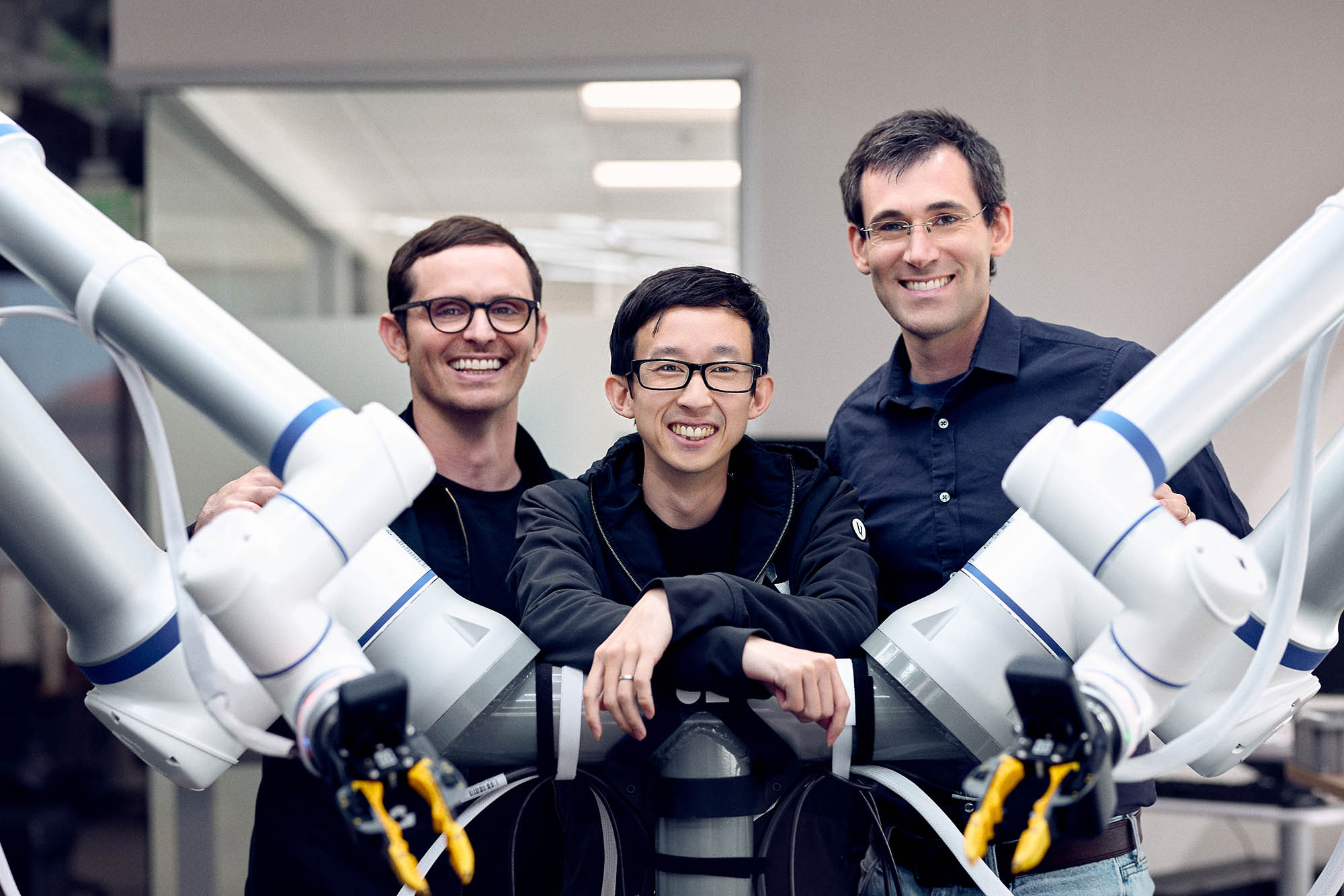 Generalist cofounders beside robotic arms