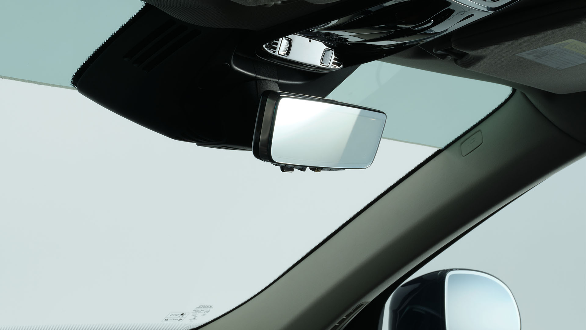 Gentex rearview mirror installed beneath a vehicle’s overhead console