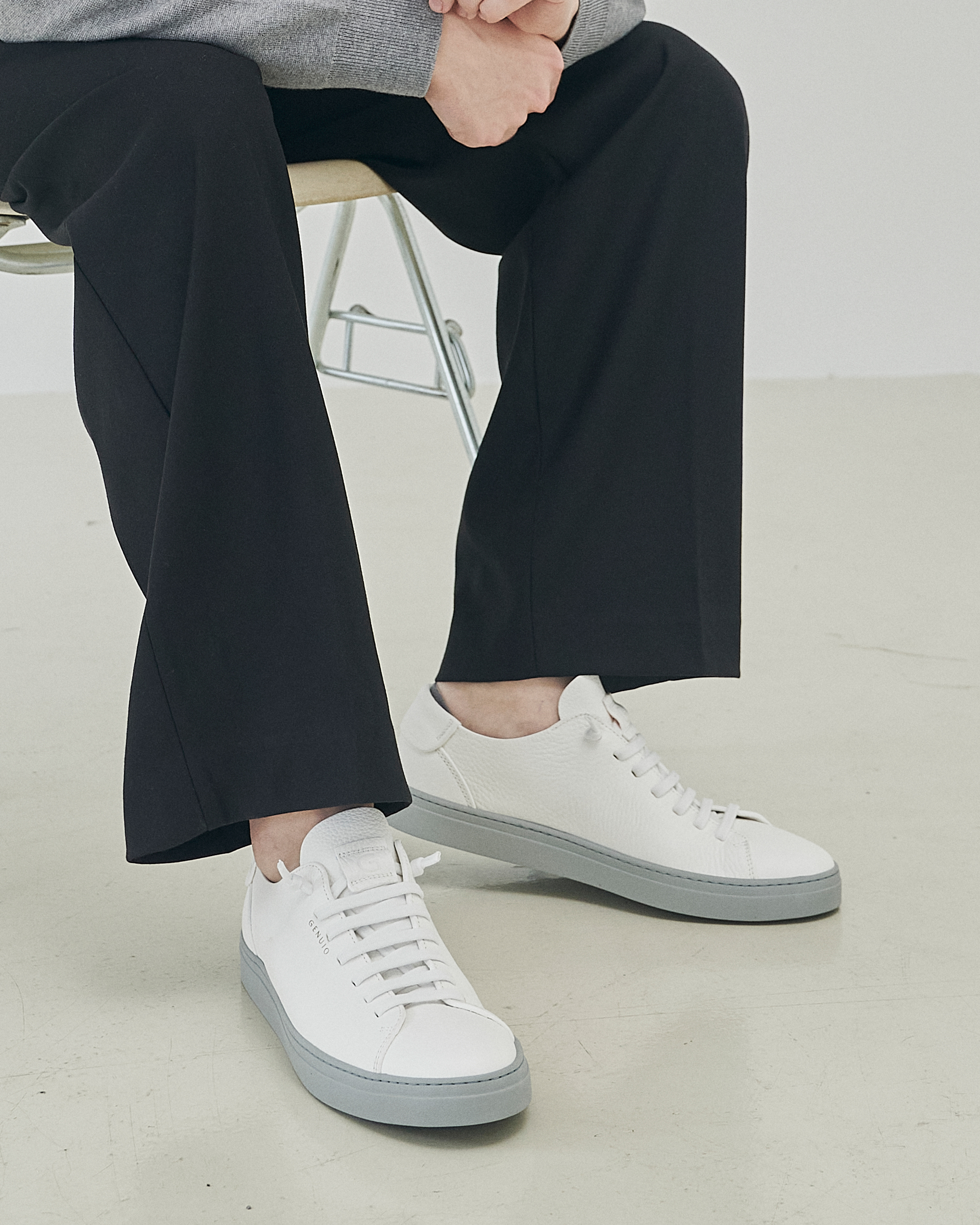 A white Genuio leather sneaker photographed in profile