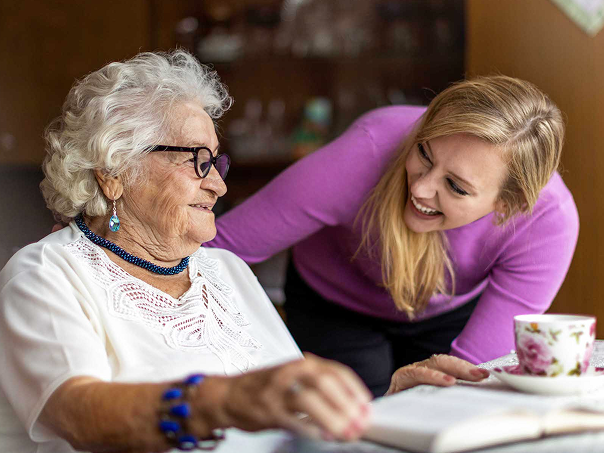 CareScout promotional photograph of two women looking at material together at a table