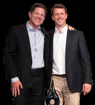 John Janes, left, and Geoff Dillon, right, smiling at the 2022 Asphalt Institute awards dinner