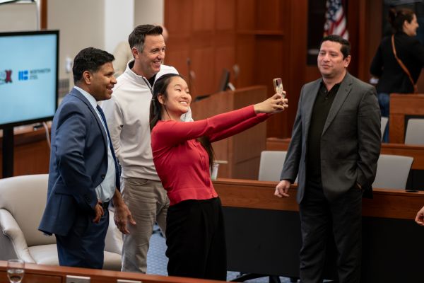 Fisher student Grace Min taking a selfie with Aravind Chandrasekaran and Geoff Gilmore