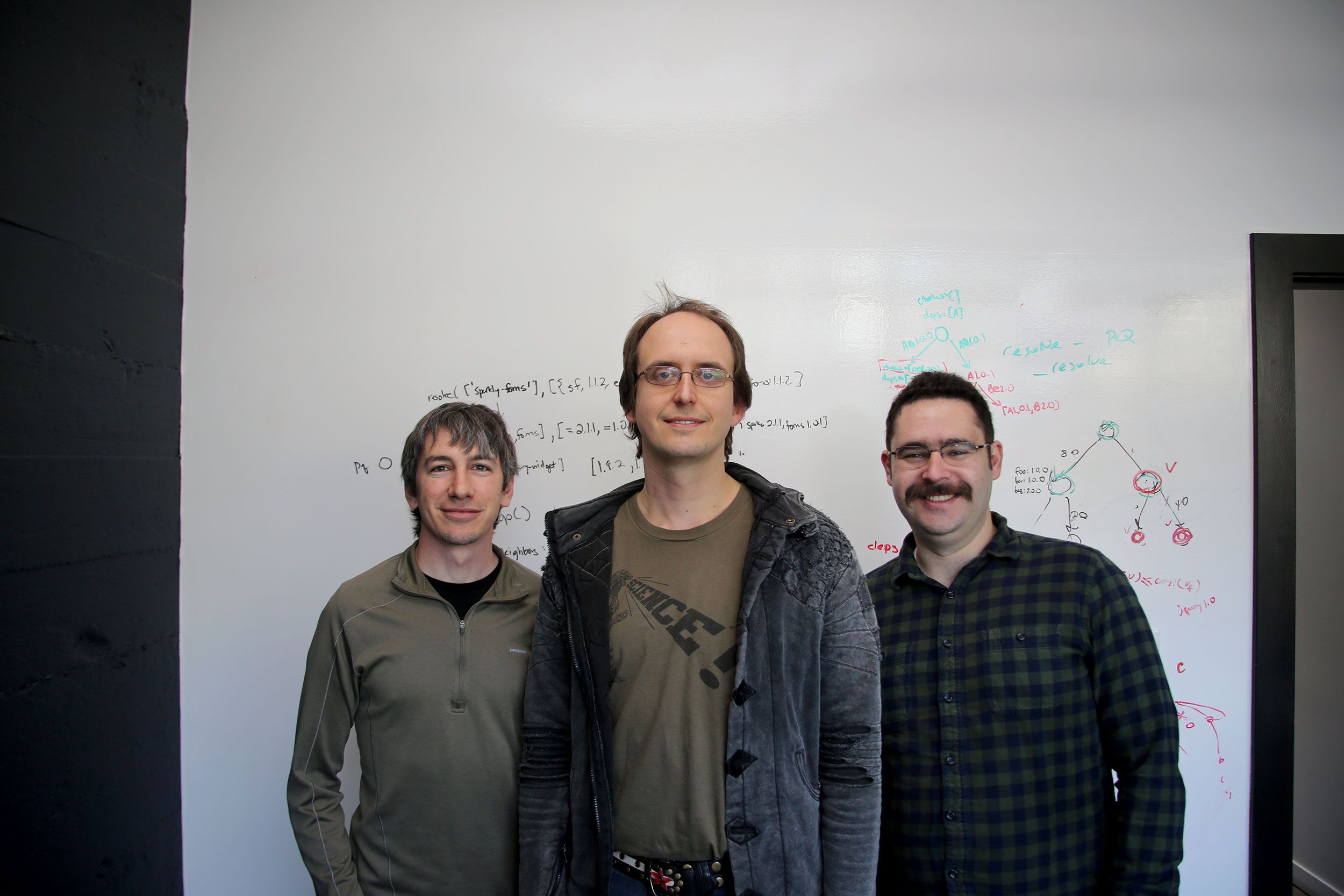 Meteor co-founders Matt DeBergalis, Geoff Schmidt and Nick Martin standing in front of a whiteboard