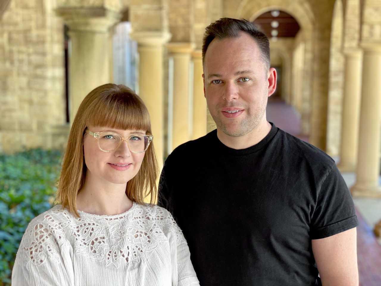 EDITED co-founders Julia Fowler and Geoff Watts standing together beneath stone arches