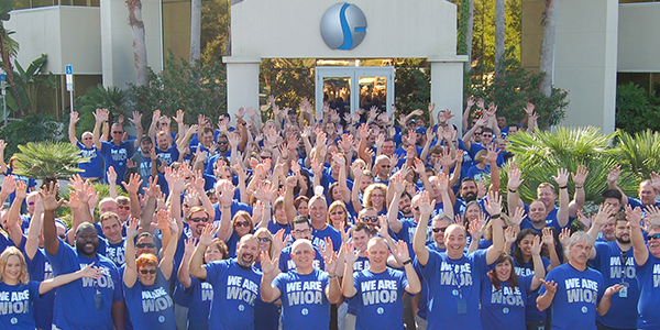 Geographic Solutions employees gathered outside the company’s Palm Harbor building for its 25th anniversary