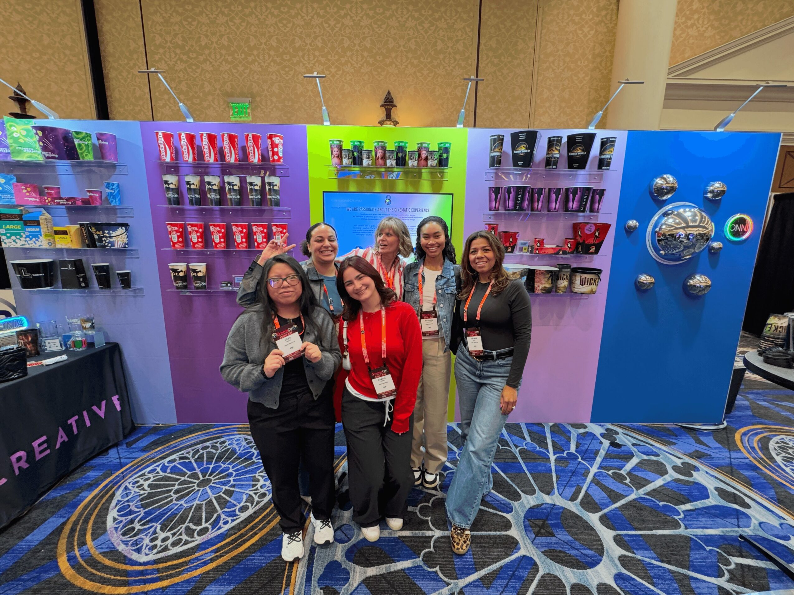 A group gathered at Onni Creative’s colorful cinema-industry exhibition booth