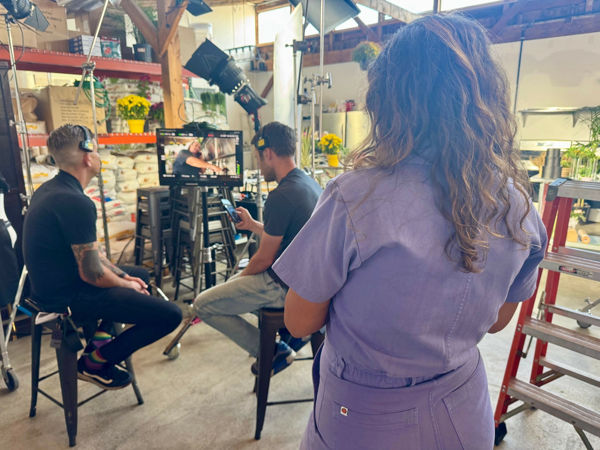 Geonni Sigl standing behind a camera crew on a working production set