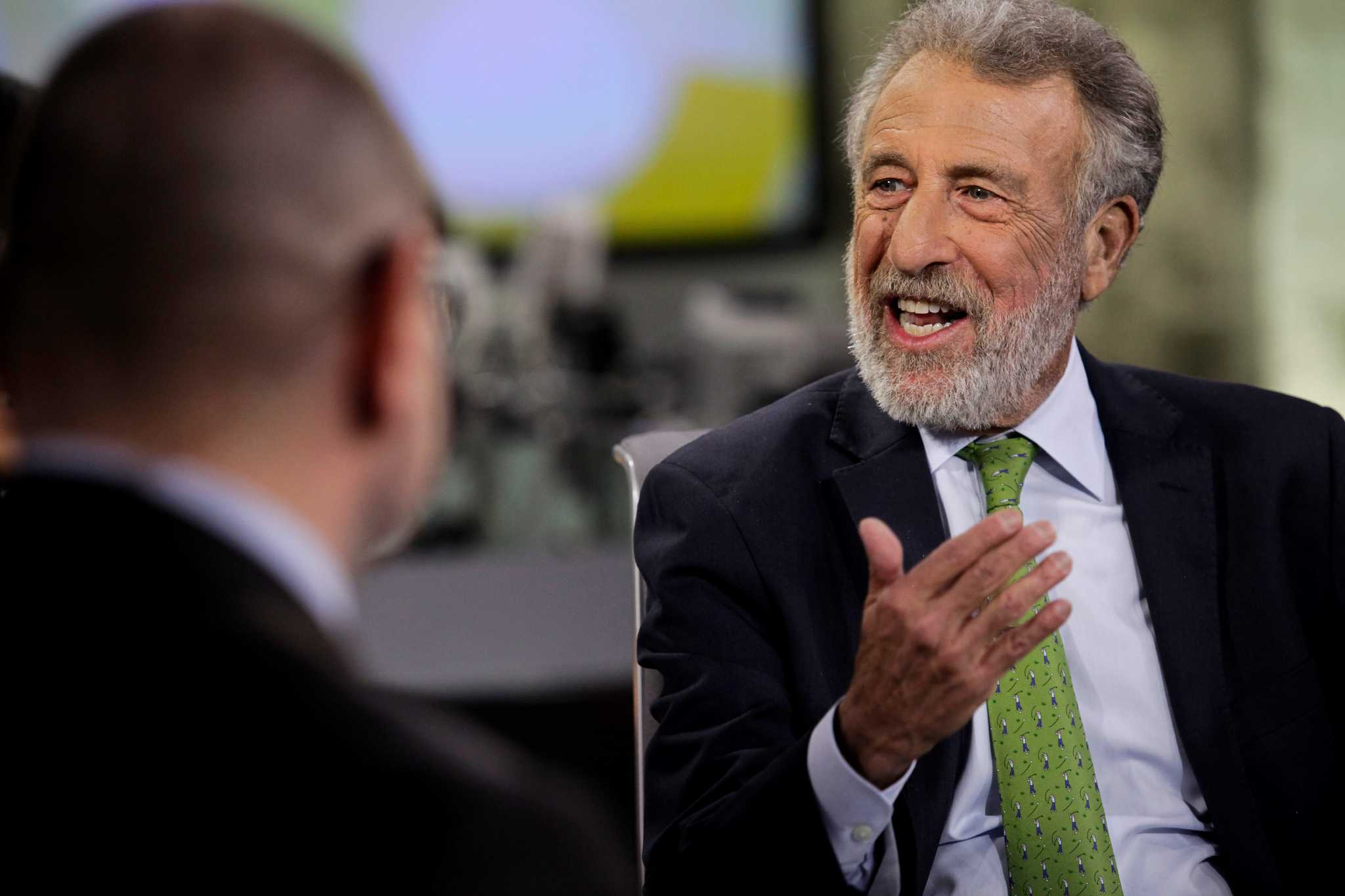 George Zimmer speaking animatedly during an interview in Oakland in 2015