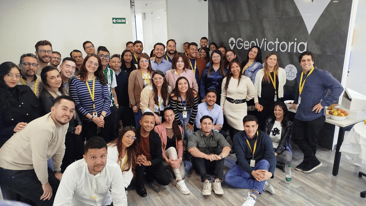 GeoVictoria colleagues posing together in an office