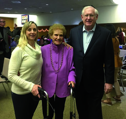 Debra Pazos, Evelyn Goodman and Jerry Rubin smiling together at Congregation B’nai Zion’s December 2017 Chanukah celebration.
