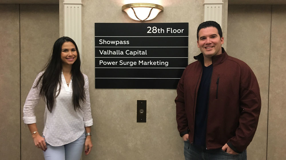 Nayka Vallejo and Gerardo Saborío Molina beside an office directory in Calgary in 2017