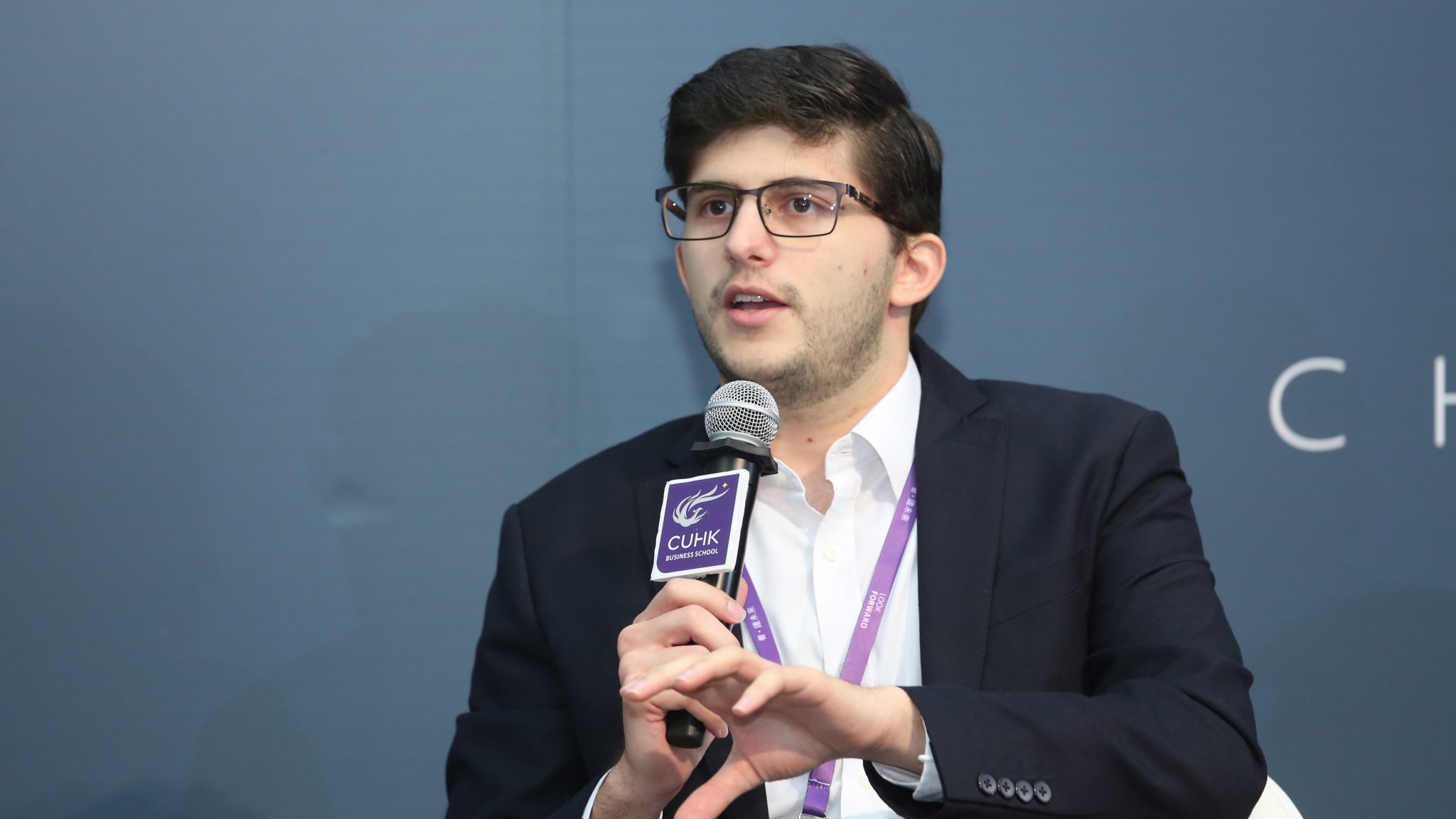 Gerardo Salandra speaking into a microphone at a CUHK Business School event