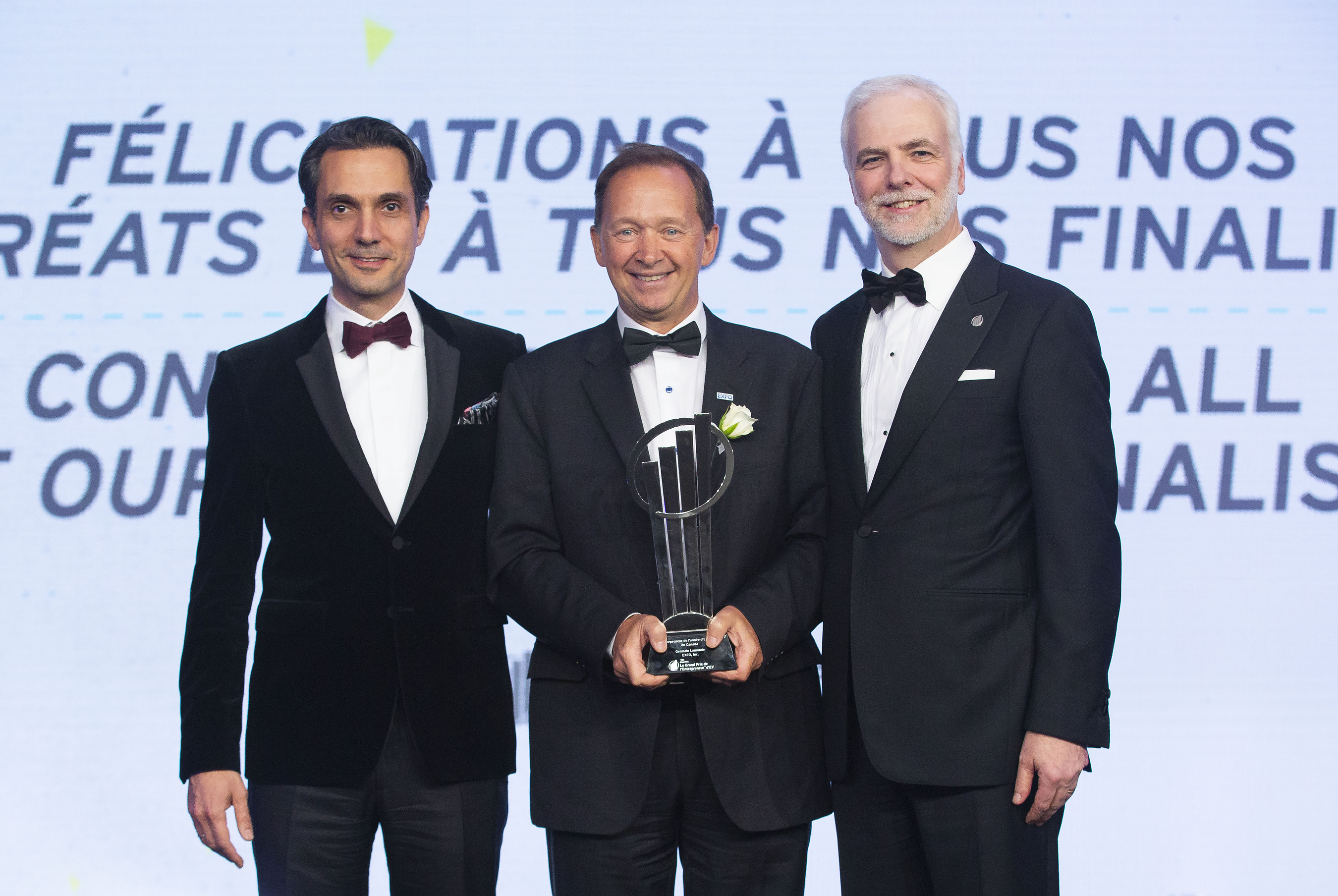 Germain Lamonde, center, accepting the 2018 Canadian EY Entrepreneur Of The Year award alongside Jad Shimaly and François Tellier
