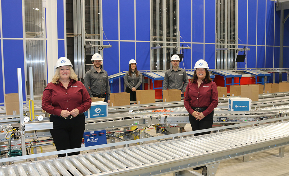 Five Gerrie Electric employees wearing hard hats in the company's automated distribution facility