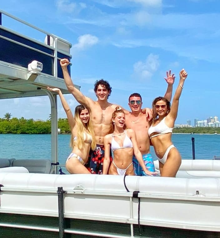 A group of friends celebrating on a pontoon boat