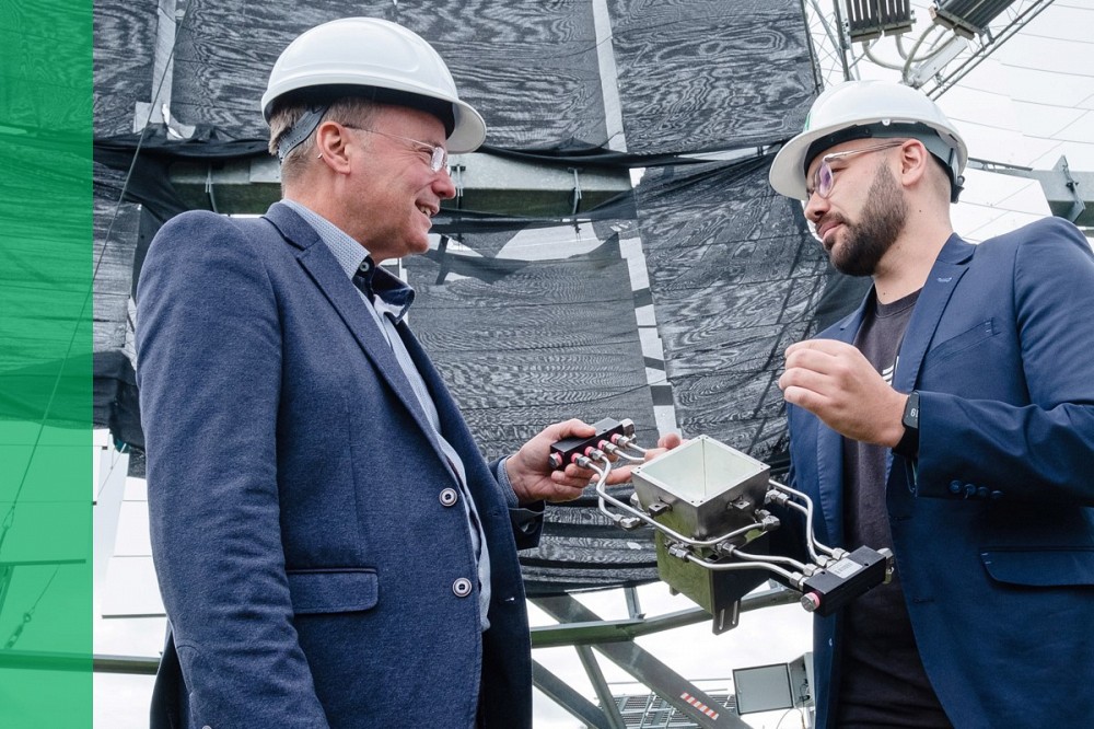 Ghyslain Goulet, left, and C-SAR cofounder Jean-François Dufault wear hard hats while discussing equipment.