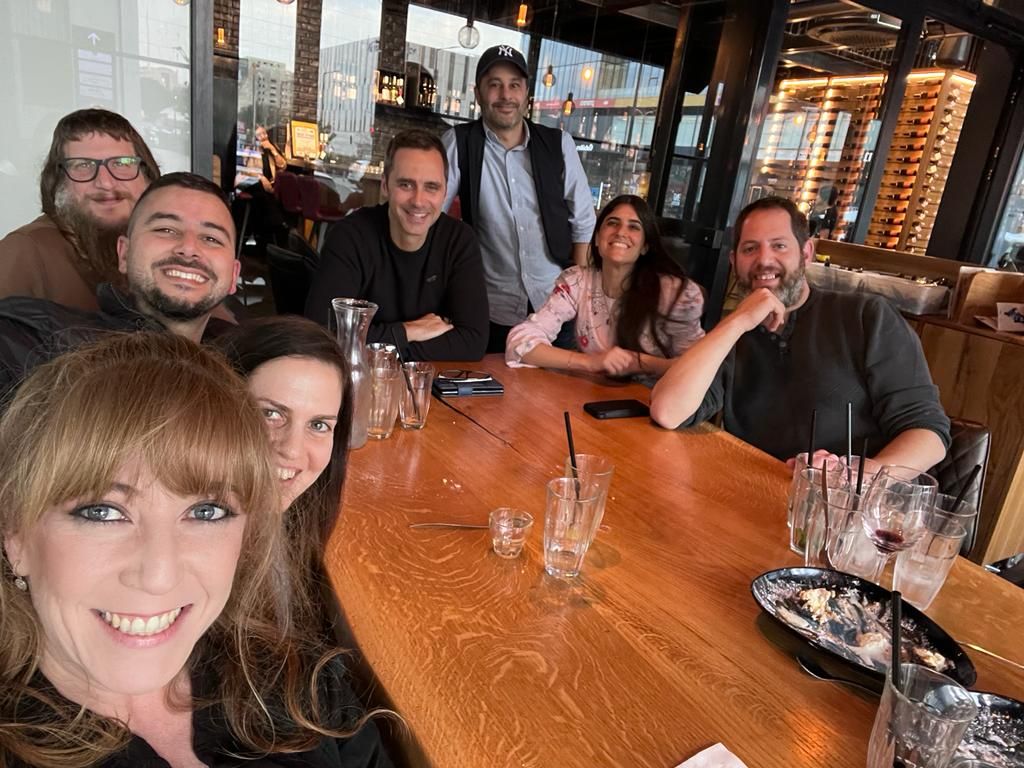 Gideon Thomas seated with members of DealHub's marketing team around a restaurant table