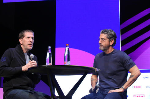 Gil Rosen seated on stage in conversation with Guy Rosen at Tech TLV